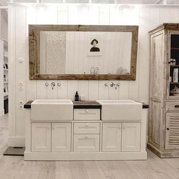 Bathroom vanity cabinet in Provence style with 2 white ceramic sinks, a wooden countertop, and a mirror in a brushed wooden frame