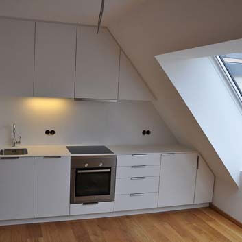 Built-in kitchen under sloping ceiling, wall-to-wall, simple, all-white kitchen, Bosch oven.