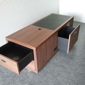 Customized sideboard, wood veneered with partial black inlay, with built-in socket and open drawers integrated into the shape