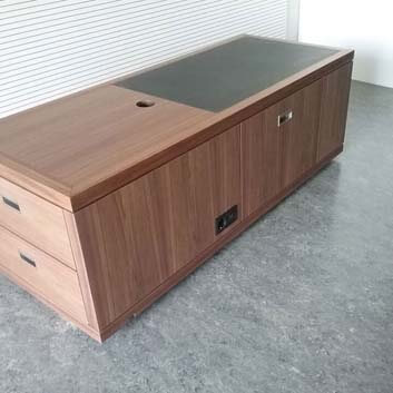Customized sideboard, wood veneered with partial black inlay, with built-in socket integrated into the shape.