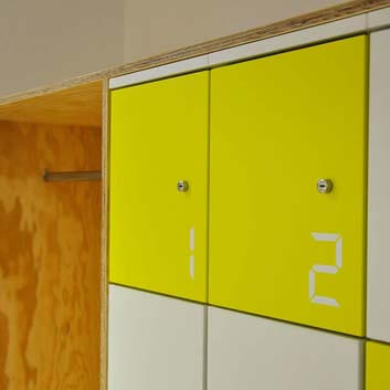 Office furniture, locker with numbers and locks, made of painted plywood, yellow and white boards.