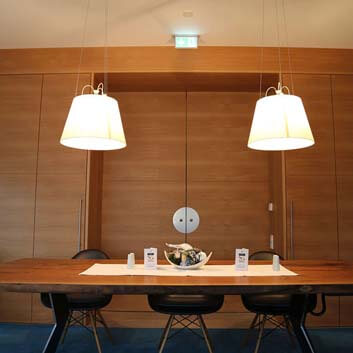 Storage solution with built-in sliding doors, long conference table, Vitra chairs