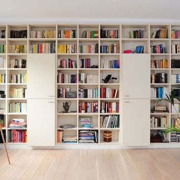 Wall-to-wall width storage system, ceiling-to-floor height, open shelves for books, and two units with 2 doors.