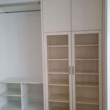 Display cabinet with glass doors and storage space in off-white.