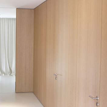 Modern, calming interior, wood-paneled walls and floor-to-ceiling doors.