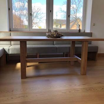 Wooden table and upholstered L-shaped bench.