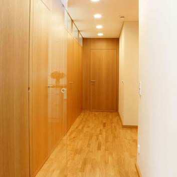 Wood-paneled hallway with invisible sliding glass doors